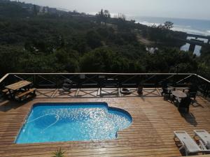 a swimming pool on top of a wooden deck at Angers Aweigh, Hibberdene Chalet 86 in Hibberdene +11 photos