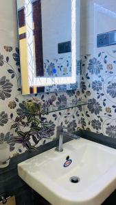 a bathroom with a sink and a mirror at Happy Haven in Hikkaduwa