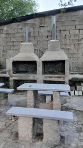 a white bench sitting next to a stone oven at Las Vertientes in Tanti