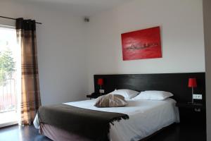 Postel nebo postele na pokoji v ubytování Hôtel Le Domaine des Vignes Ampuis Lyon Sud Vienne