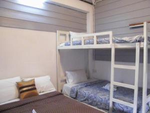 a room with two bunk beds and a bed at LUCKY PAI Resort&Hostel in Pai +6 photos