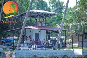 a group of people standing on a ride in a park at Orchid Lake View Resort in Paravūr