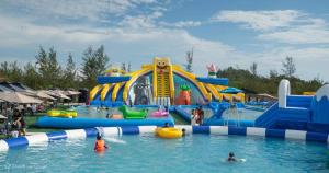a water park with a water slide and people in the water at My Homestay in Tuaran