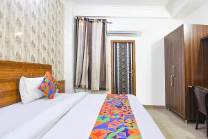 una camera da letto con un cuscino colorato di FabHotel Divine a Gurgaon