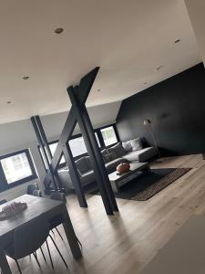 a living room with a couch and a table at NEOZONE Appart-Hotel Malmedy in Malmedy