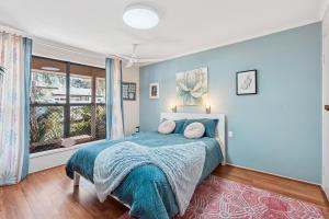 a bedroom with a bed and a large window at Exclusive Living for Professionals in Seacliff