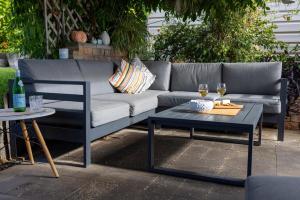 a couch and a table and two glasses of wine at Exclusive Living for Professionals in Seacliff