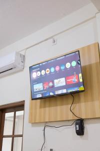 a flat screen tv hanging on a wall at Elmo Living in Yogyakarta
