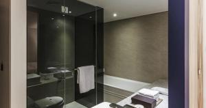 a bathroom with a glass shower with a toilet at Seocho H hotel in Seoul