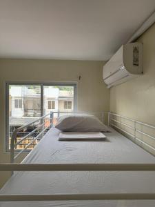 a large bed in a room with a window at BLJ Homes in Angatan