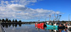 two boats are docked at a dock in the water at Albatross Motel in Lakes Entrance