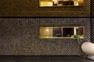 a room with a wall with a mirror at Seocho H hotel in Seoul