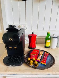 a coffee maker on a counter with a tray of food at Noosa River Gem in Noosaville