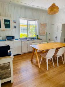 a large kitchen with a wooden table and chairs at Noosa River Gem in Noosaville