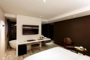 a bedroom with a bed and a bathroom with a tub at Seocho H hotel in Seoul +11 photos