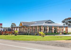 a large building on the side of a road at Marulan Motor Inn in Marulan