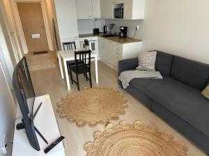 a living room with a gray couch and a table at Style 1BR with sauna&balcony in Vantaa