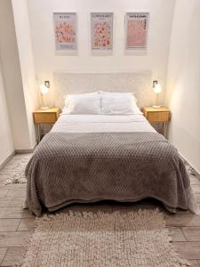 a bedroom with a large bed with two night stands at Martita House in Clorinda