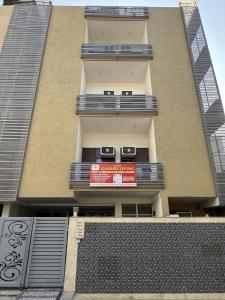 a building with a sign on the side of it at Ganesh Living in Gurgaon