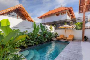 a villa with a swimming pool and a house at The Lok's Villa in Ubud