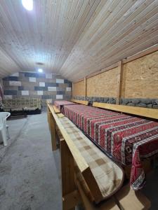 a row of beds in a room with a ceiling at Madoyans Rest House in Antarut +57 photos