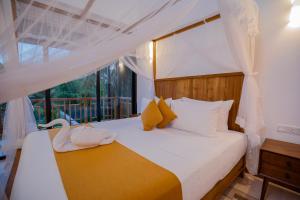 a bedroom with a bed with a swan on it at La Lassaura in Unawatuna +99 photos