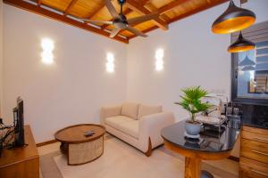 a living room with a couch and a table at La Lassaura in Unawatuna