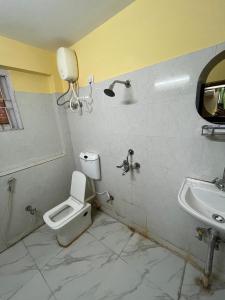 a bathroom with a toilet and a sink at PlatinumIN Guesthouse in kolkata
