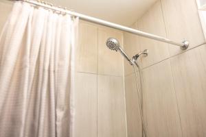 a shower in a bathroom with a shower curtain at Airende in Newark