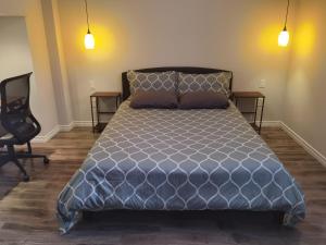 a bedroom with a large bed and a chair at Cozy Suite! Separate Entry, 1 Parking in Newmarket