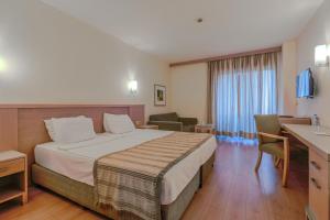 a hotel room with a bed and a desk at Sural Resort Hotel in Side +60 photos