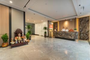 a lobby of a hotel with people standing at a counter at Lam Anh Hotel 9 Him Lam Vạn Phúc in Hà Ðông