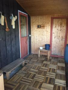 a room with a red door and a wooden floor at Saagala Village in Tornio