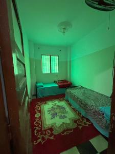 a small room with two beds and a rug at Alaraby 2 in Az Zaytīyah