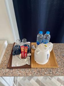 a tray with a tea kettle and two bottles of water at Baan Klang Khao Mountain Viewบ้านกลางเขา เมาเทนวิว in Nong Nam Daeng