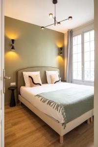 a bedroom with a bed and a large window at Charming and spacious air-conditioned apartment in Le Pré-Saint-Gervais