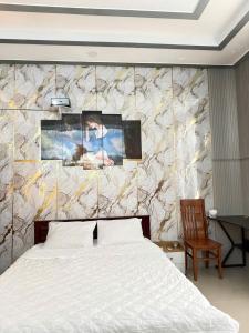 a bedroom with a bed and a marble wall at Motel Long Thành Quang in Long Thành +6 photos