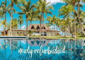 a view of a resort with palm trees and a swimming pool at Paradise Sun Hotel Seychelles in Baie Sainte Anne