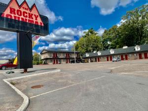 an empty parking lot in front of a motel at Rocky Mountain Lodge & Suites in Renfrew