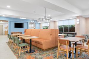 a waiting room with tables and a couch at Hampton Inn Midland West in Midland
