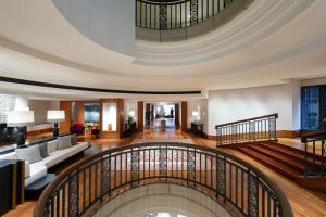a spiral staircase in a building with a lobby at Conrad Hamburg in Hamburg +144 photos
