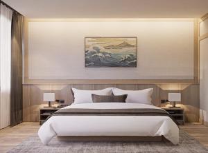 a bedroom with a large bed and a painting on the wall at Zen Essence Khao Yai in Ban Tha Maprang