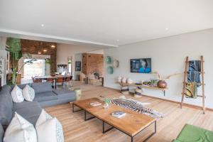 a living room with a couch and a table at Star Dam Lodges in Dargle