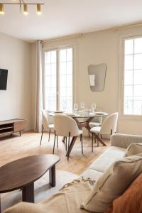 a living room with a table and chairs at Elegant, fully-equipped, air-conditioned accommodation in Le Pré-Saint-Gervais +11 photos