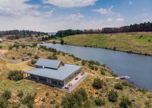 an aerial view of a house next to a river at Star Dam Lodges in Dargle