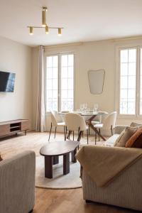 a living room with a couch and a table at Elegant, fully-equipped, air-conditioned accommodation in Le Pré-Saint-Gervais
