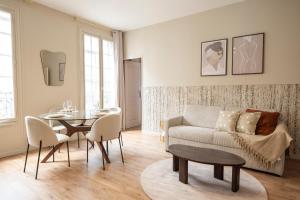a living room with a couch and a table at Elegant, fully-equipped, air-conditioned accommodation in Le Pré-Saint-Gervais