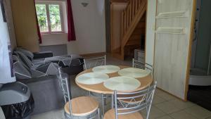 a living room with a table and chairs and a couch at Independent studio in nature in Saint-Valérien