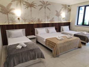 a bedroom with two beds with towels on them at Palmen Villa Gabala in Gabala +88 photos