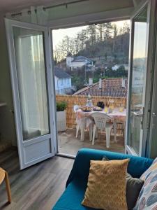 a living room with a couch and a sliding glass door at Gîte l'Ermitage in Cahors +5 photos